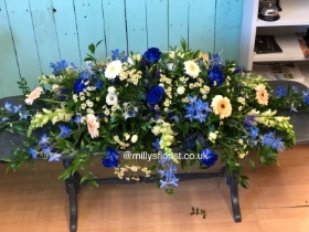 Blue, white, cream casket spray